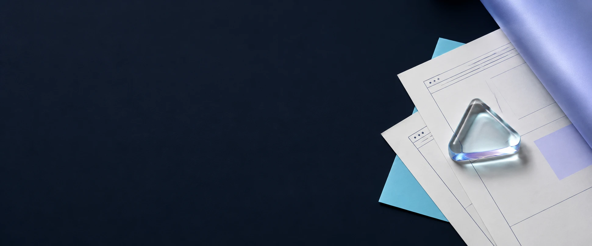 Editorial flat-lay on a dark background showing an online shop homepage design and a mobile checkout screen, styled with glass prism accents